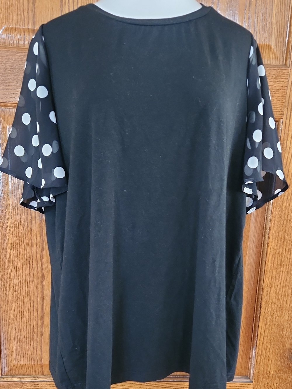 BloomChic Black Top with White Polka Dot Sleeves